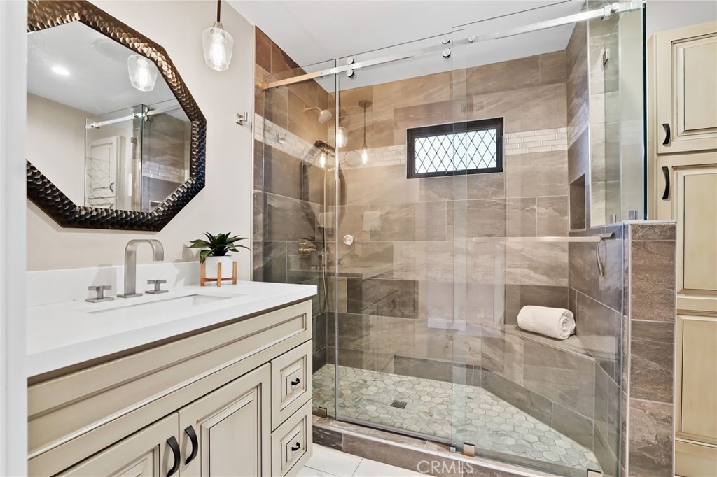 1810 Tanager Drive Costa Mesa, CA 92626 - Photo 22 of 55 a bathroom with a sink mirror and a shower