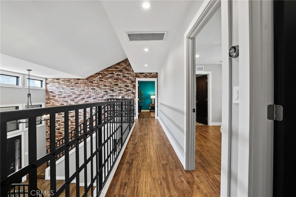 1810 Tanager Drive Costa Mesa, CA 92626 - Photo 27 of 55 a view of a hallway with wooden floor and staircase
