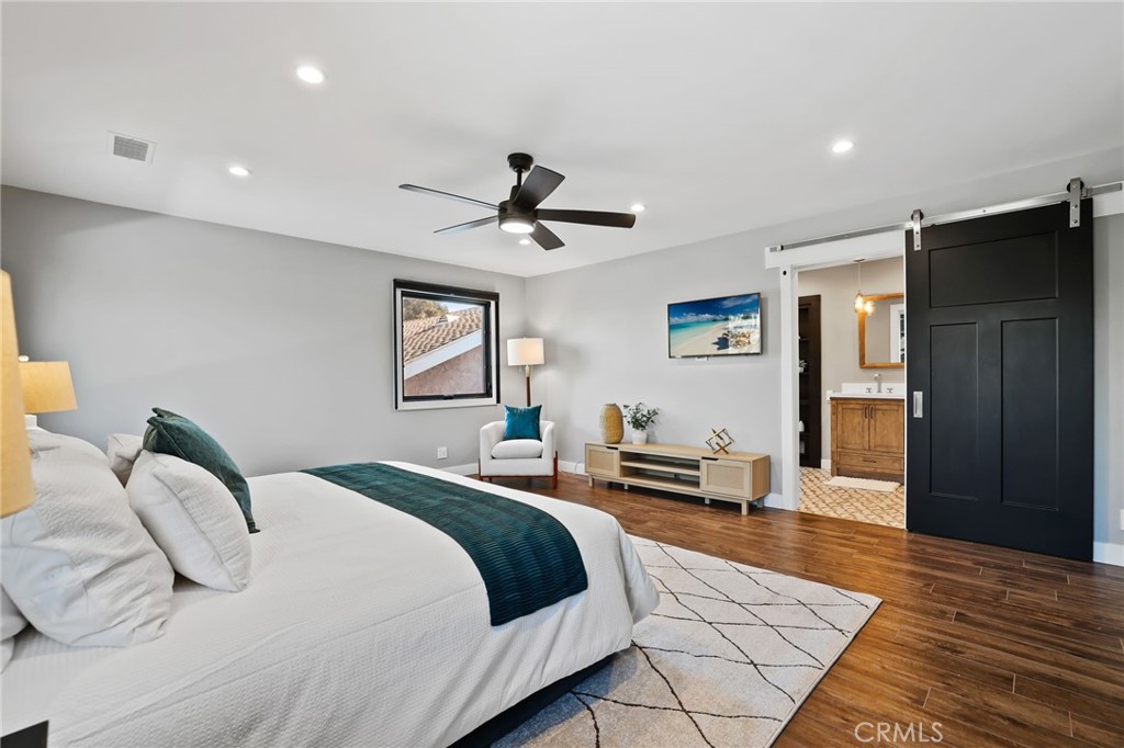 1810 Tanager Drive Costa Mesa, CA 92626 - Photo 32 of 55 a bedroom with a bed and a chandelier