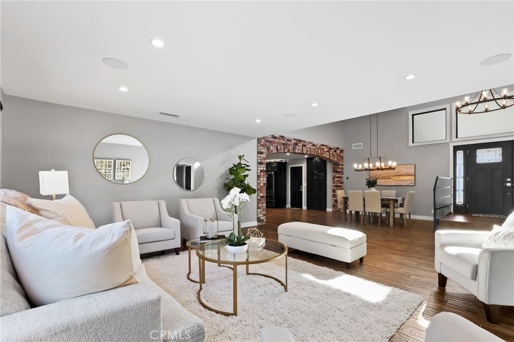 1810 Tanager Drive Costa Mesa, CA 92626 - Photo 9 of 55 a living room with furniture a clock on wall and a table