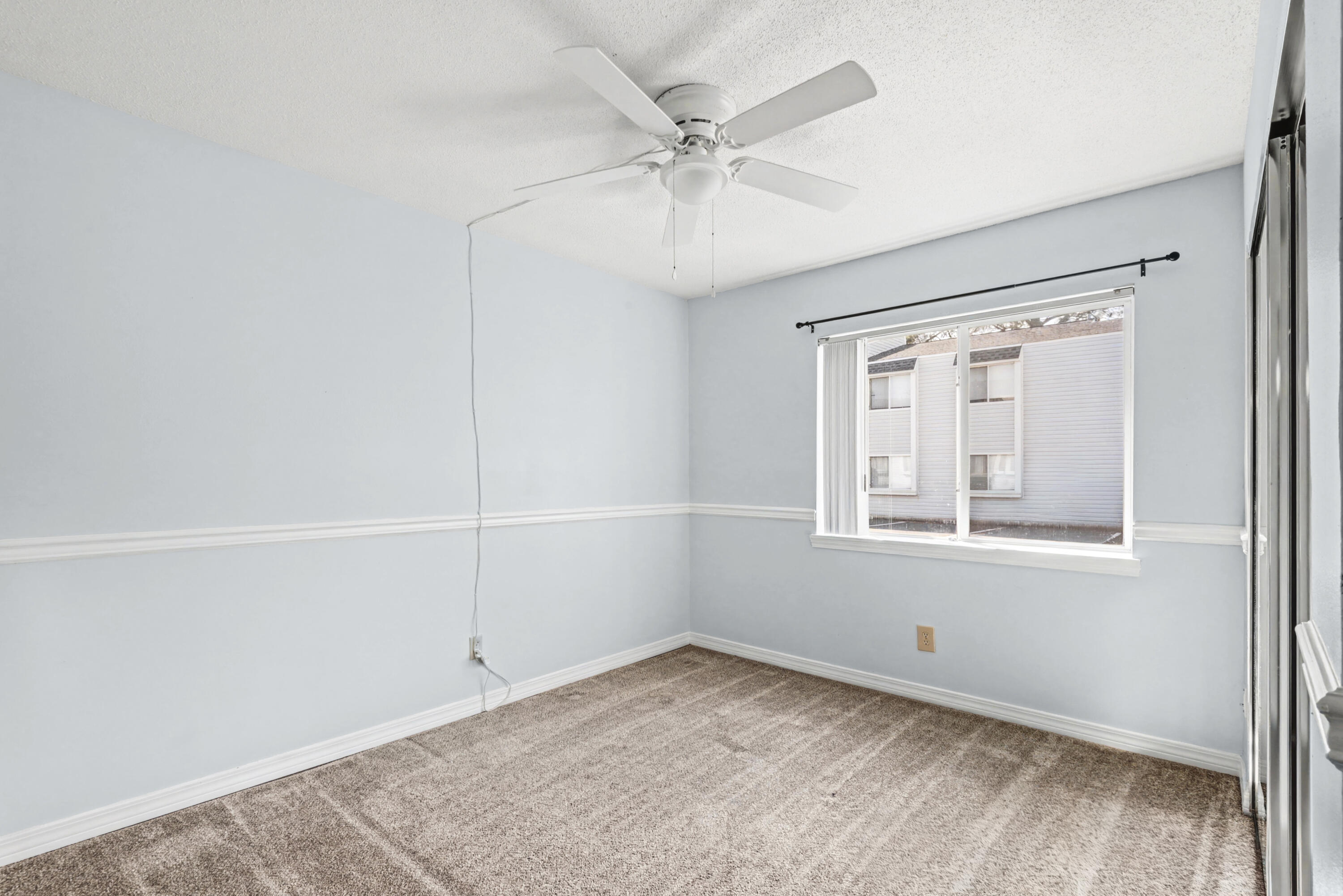 101 Old Ferry Road, Unit 10B Shalimar, FL 32579 - Photo 12 of 30 an empty room with a window and a fan