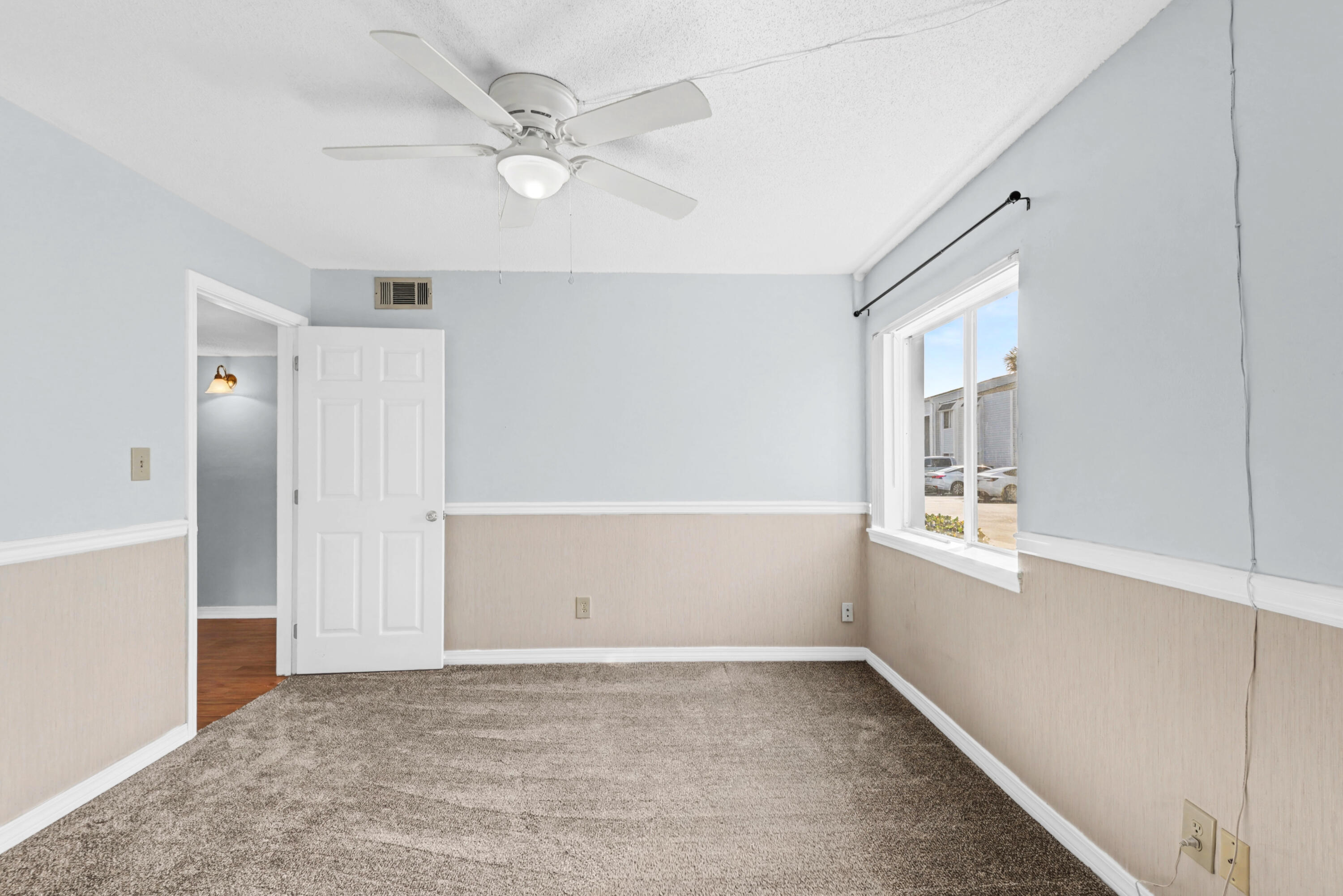 101 Old Ferry Road, Unit 10B Shalimar, FL 32579 - Photo 18 of 30 wooden floor in an empty room with a window