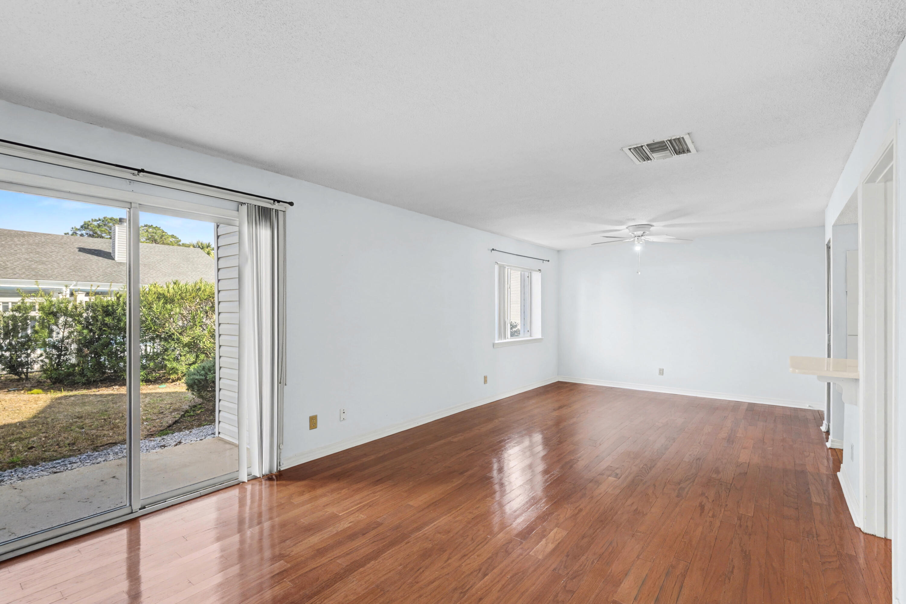 101 Old Ferry Road, Unit 10B Shalimar, FL 32579 - Photo 5 of 30 an empty room with wooden floor and windows