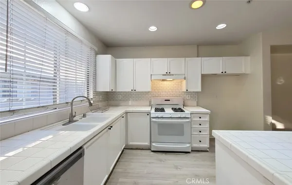a view of a kitchen with a sink and dishwasher