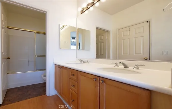 a view of a hallway with closet and wooden floor