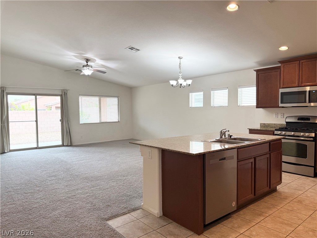 8231 Buffalo Ranch Avenue Las Vegas, NV 89147 - Photo 6 of 22 An inviting open-concept layout unites the kitchen and living space, offering generous gathering areas.