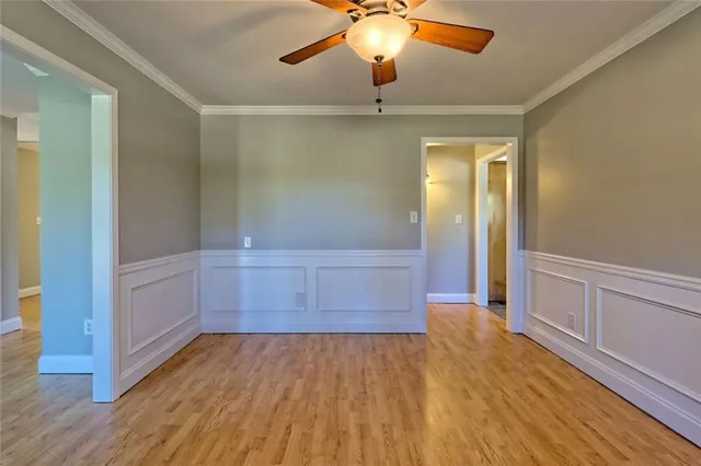 a view of a livingroom with a ceiling fan and window