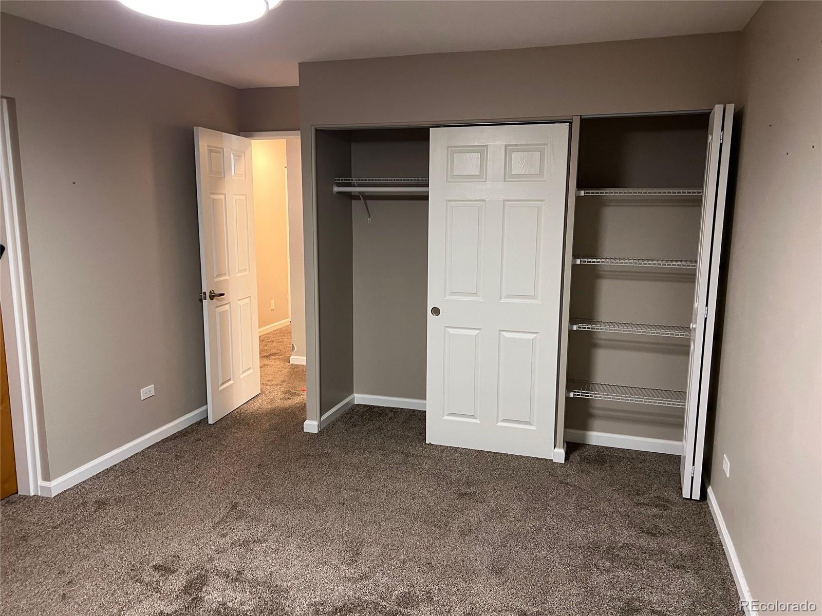 660 South Alton Way, Unit 4A Denver, CO 80247 - Photo 13 of 28 a view of an empty room with closet and a window