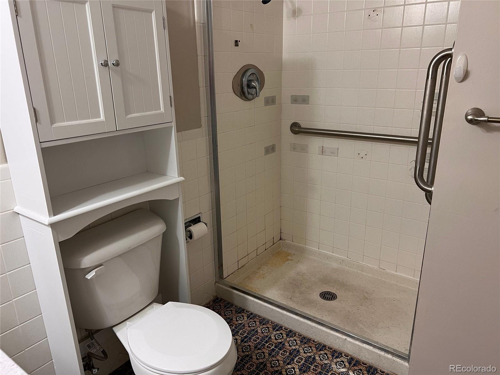660 South Alton Way, Unit 4A Denver, CO 80247 - Photo 19 of 28 a bathroom with a shower a toilet and a sink