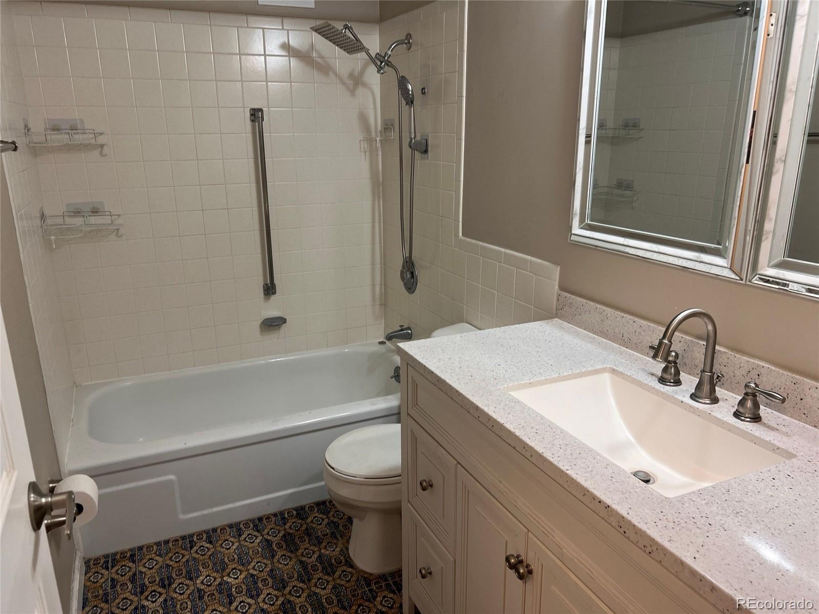 660 South Alton Way, Unit 4A Denver, CO 80247 - Photo 20 of 28 a bathroom with a granite countertop sink toilet and shower