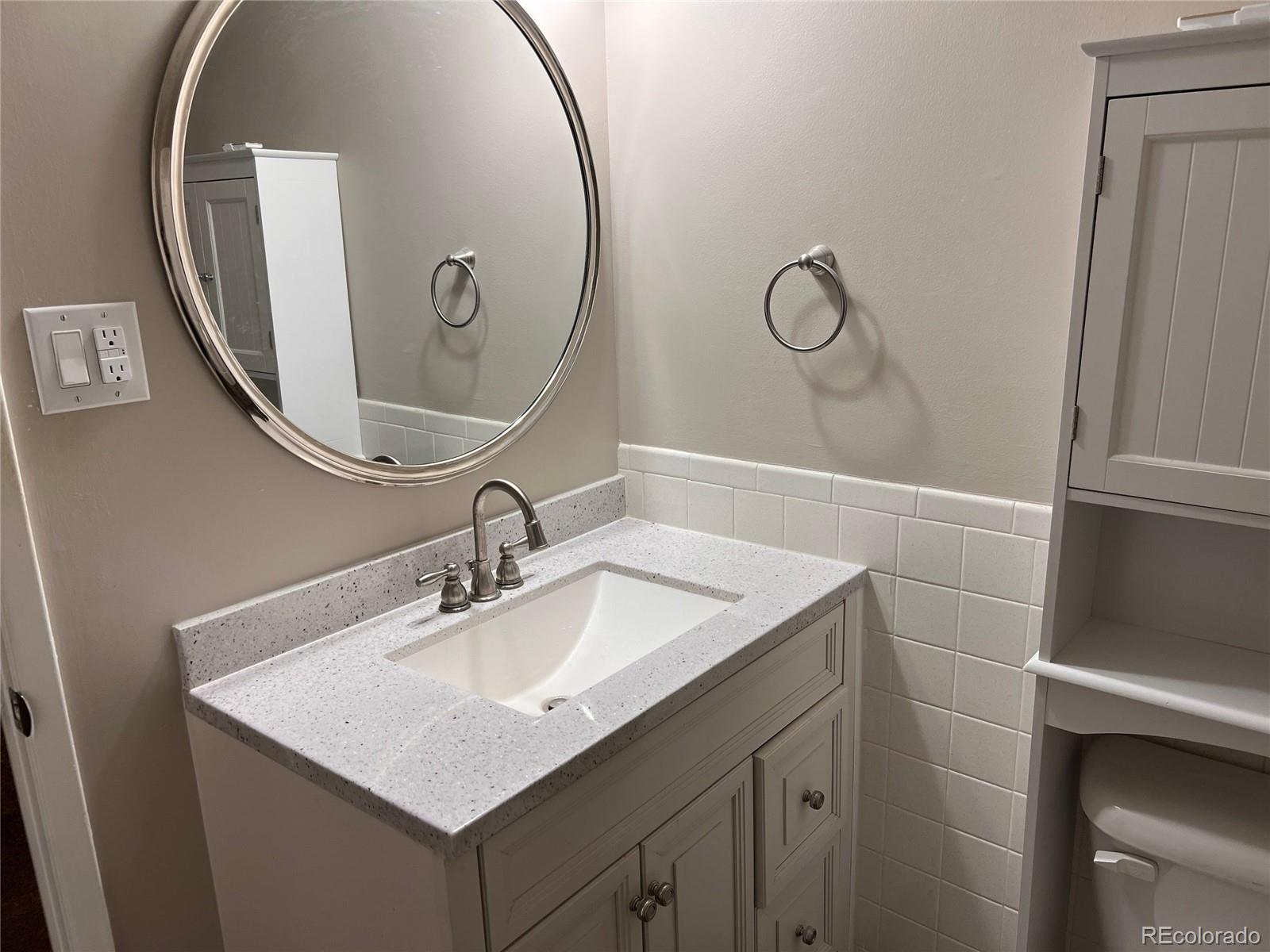 660 South Alton Way, Unit 4A Denver, CO 80247 - Photo 21 of 28 a bathroom with a sink vanity and a mirror