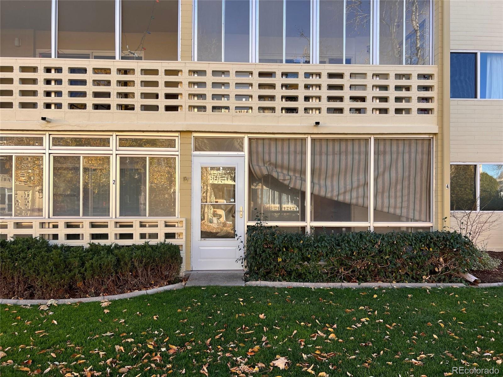 660 South Alton Way, Unit 4A Denver, CO 80247 - Photo 27 of 28 front view of a house with a yard