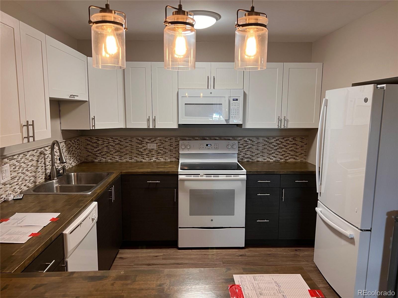 660 South Alton Way, Unit 4A Denver, CO 80247 - Photo 10 of 28 a kitchen with cabinets appliances and a counter space