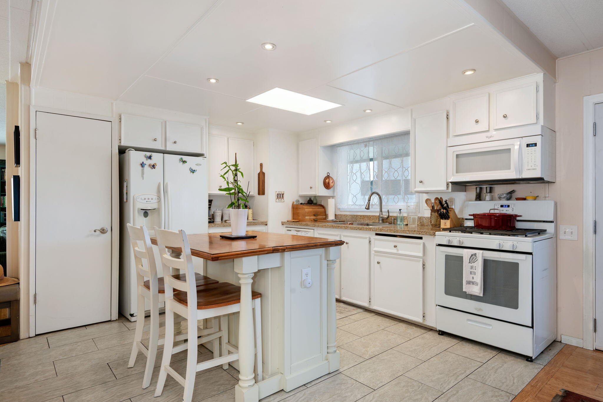 6180 Via Real, Unit 32 Carpinteria, CA 93013 - Photo 11 of 34 a kitchen with stainless steel appliances granite countertop a white cabinets and a refrigerator