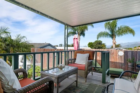 a view of a balcony with chairs and a table
