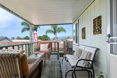 a view of a chairs and table in the balcony