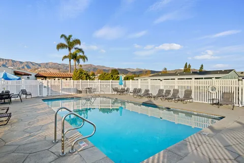 a view of a swimming pool with outdoor seating