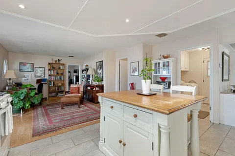 a view of kitchen island a sink and living room