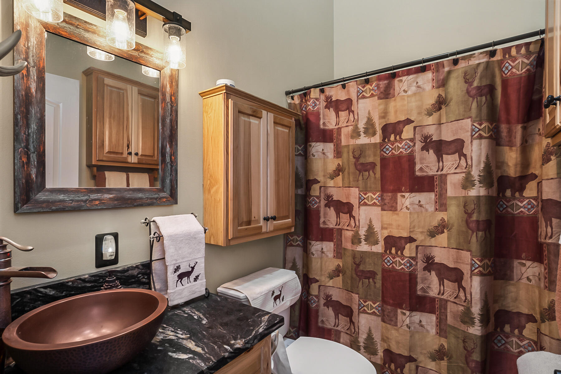 15730 Jackpine Road La Pine, OR 97739 - Photo 22 of 43 a bathroom with a sink toilet a mirror and shower curtain