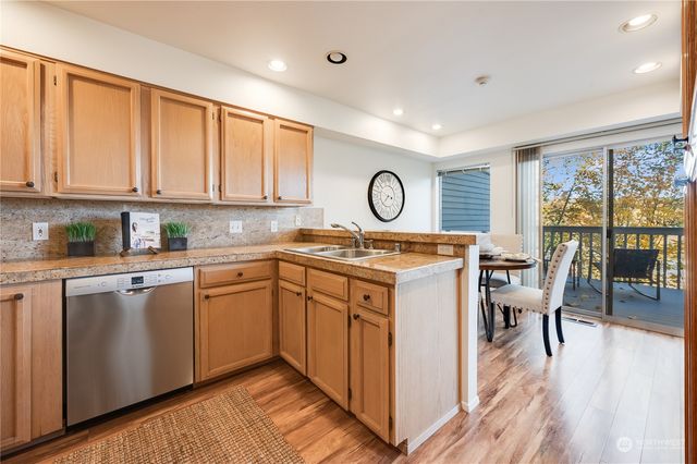 a kitchen with a sink cabinets and wooden floor