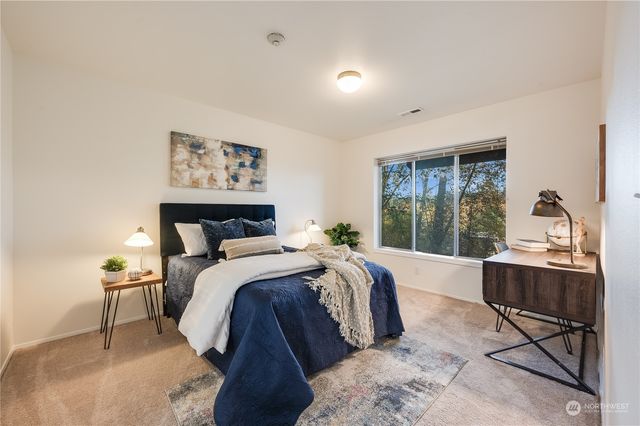 a bed room with a bed and a chair