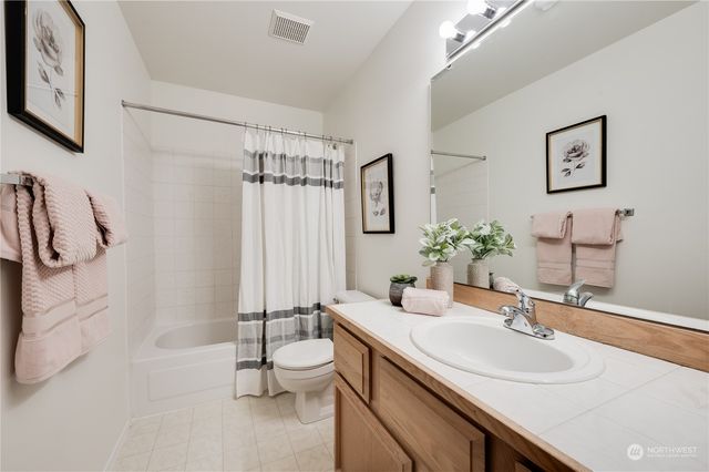 a bathroom with a sink toilet a mirror and shower