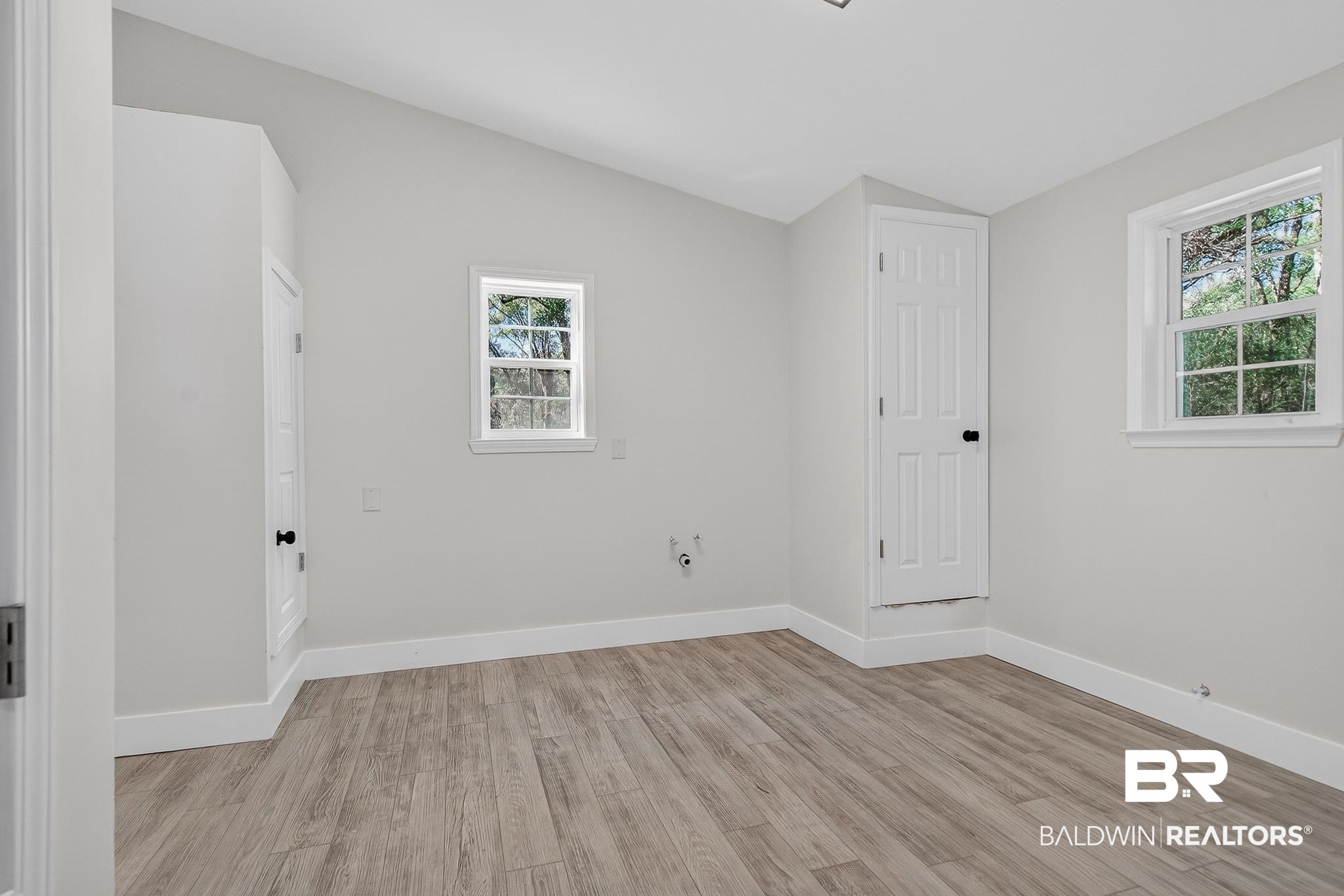 10650 Old Pascagoula Road Theodore, AL 36582 - Photo 53 of 77 Spare room with vaulted ceiling and light wood-style floors