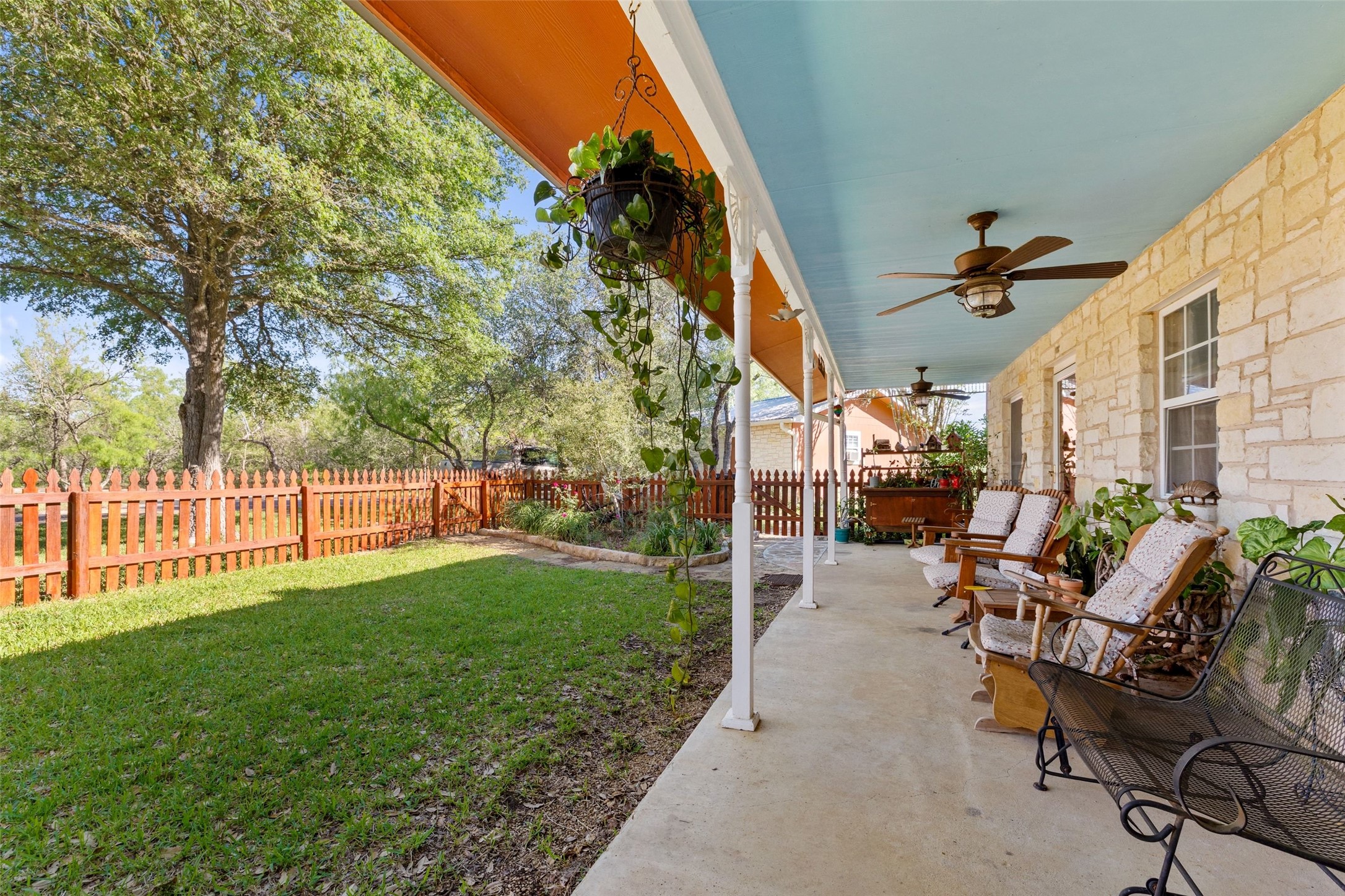 399 Upper Elgin River Road Elgin, TX 78621 - Photo 27 of 39 Fenced backyard featuring a ceiling fan and a patio area