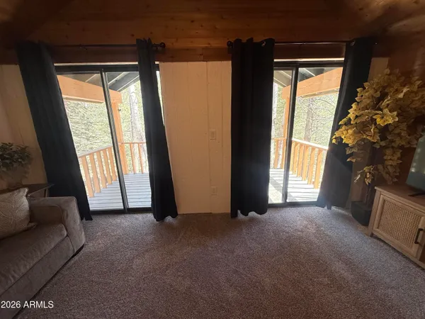 a living room with furniture pool table and a chandelier