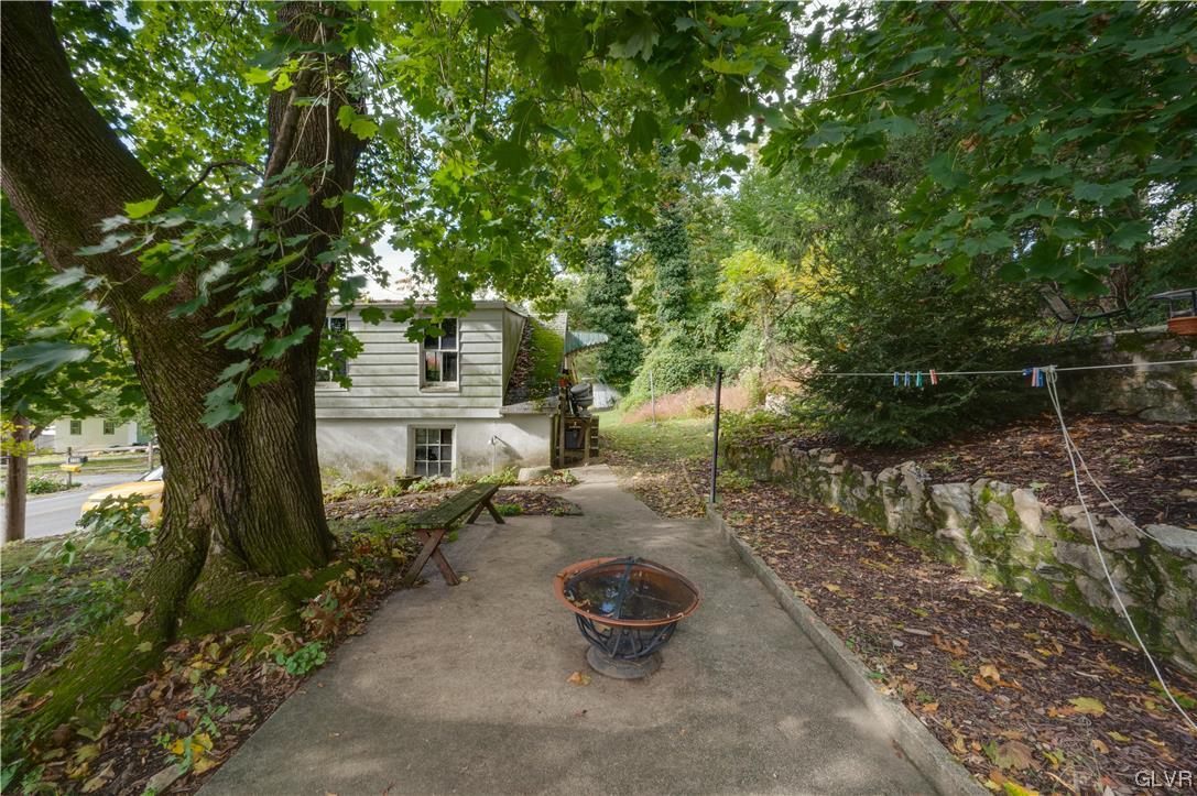 1767 Ramich Road Temple, PA 19560 - Photo 9 of 35 a backyard of a house with barbeque oven fire pit table and chairs