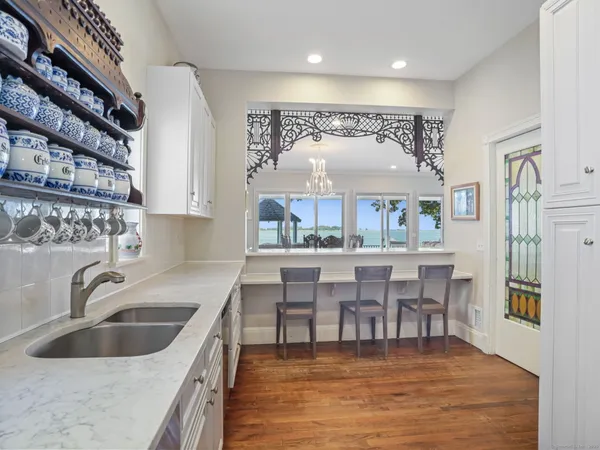 a kitchen with stainless steel appliances granite countertop a sink and a refrigerator