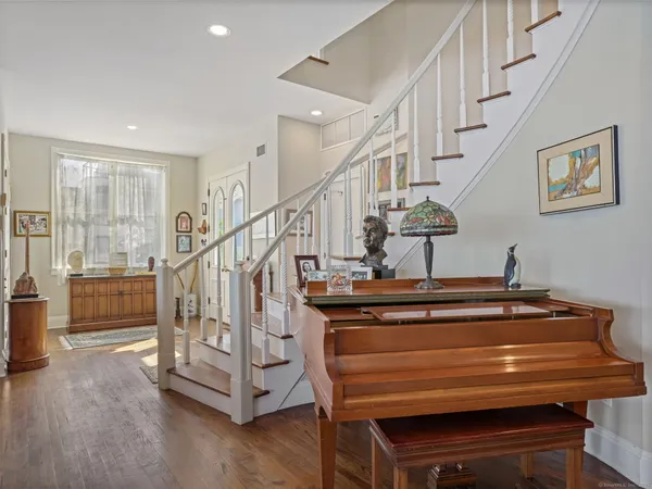 a view of entryway and hall with wooden floor