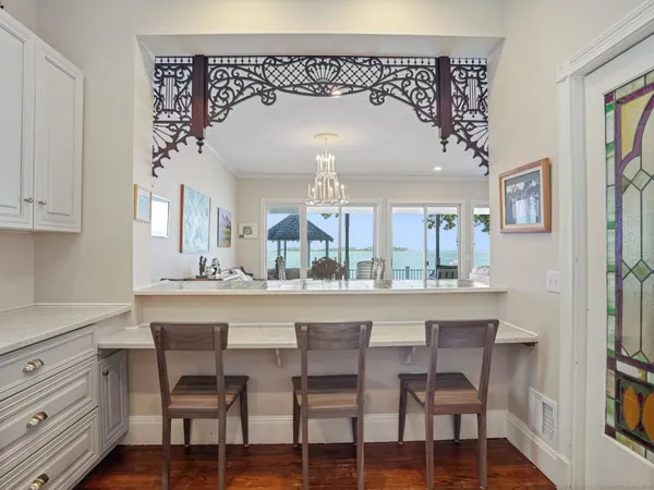 a dining room with a table chairs and a kitchen view