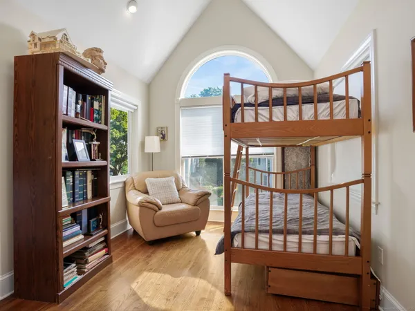a living room with furniture a rug and a book shelf