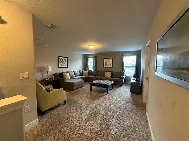 a living room with furniture and a potted plant