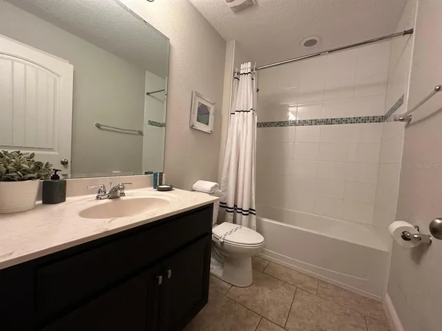 a bathroom with a sink toilet double vanity and shower