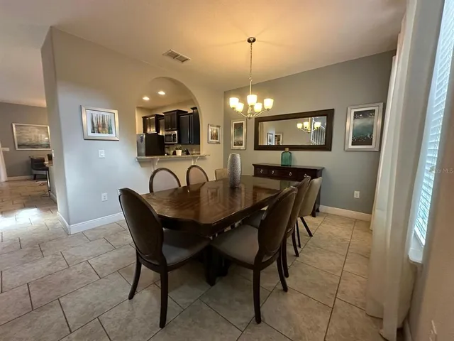 a view of a dining room with furniture and chandelier