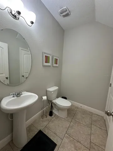 a bathroom with a sink toilet and mirror