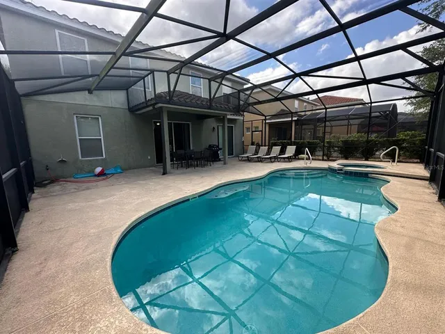 a view of a swimming pool with a patio
