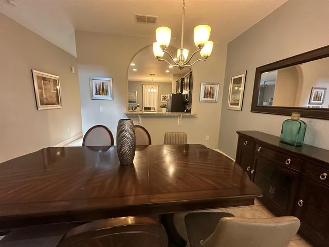 a view of a dining room with furniture and chandelier