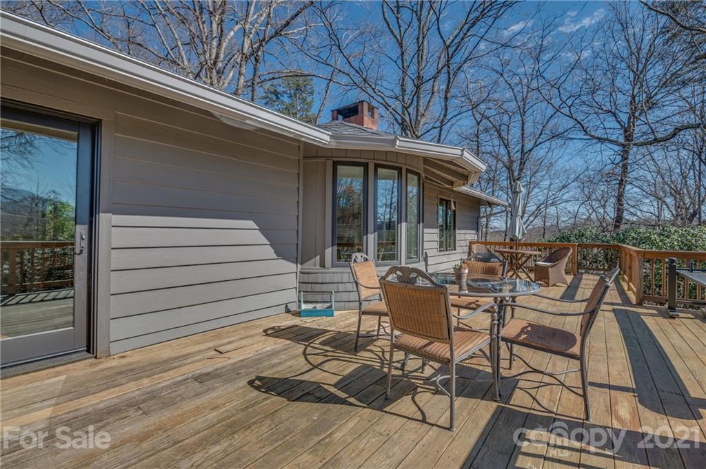 172 Wilderness Road Tryon, NC 28782 - Photo 20 of 46 a view of a patio with table and chairs and wooden floor