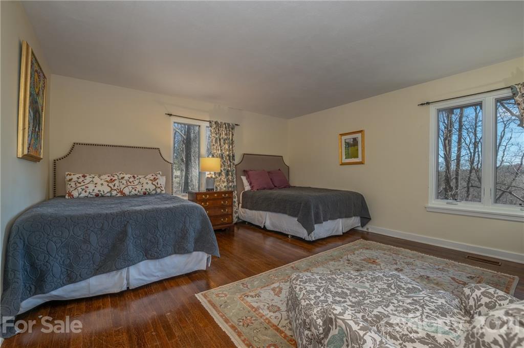 172 Wilderness Road Tryon, NC 28782 - Photo 24 of 46 a bedroom with a bed and wooden floor