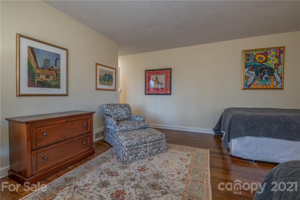 172 Wilderness Road Tryon, NC 28782 - Photo 25 of 46 a bedroom with a bed and a painting on the wall