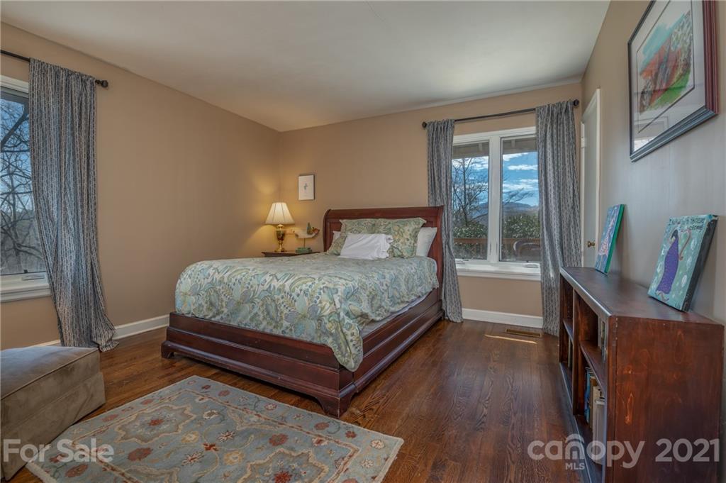 172 Wilderness Road Tryon, NC 28782 - Photo 30 of 46 a bedroom with a bed and wooden floor
