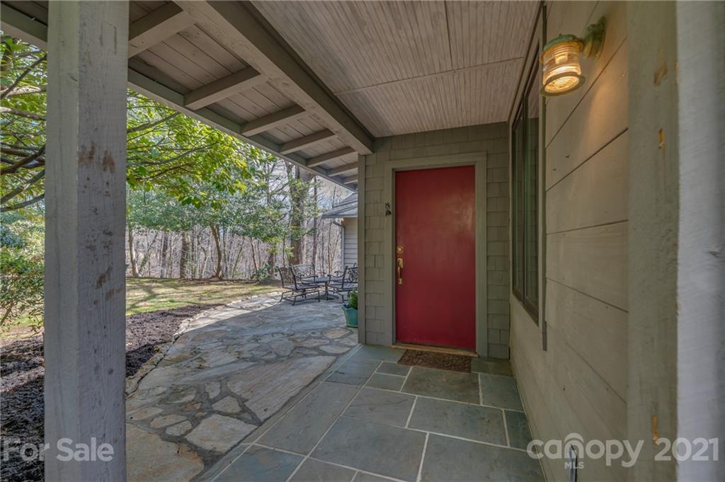 172 Wilderness Road Tryon, NC 28782 - Photo 4 of 46 a view of a house with a door and wooden fence