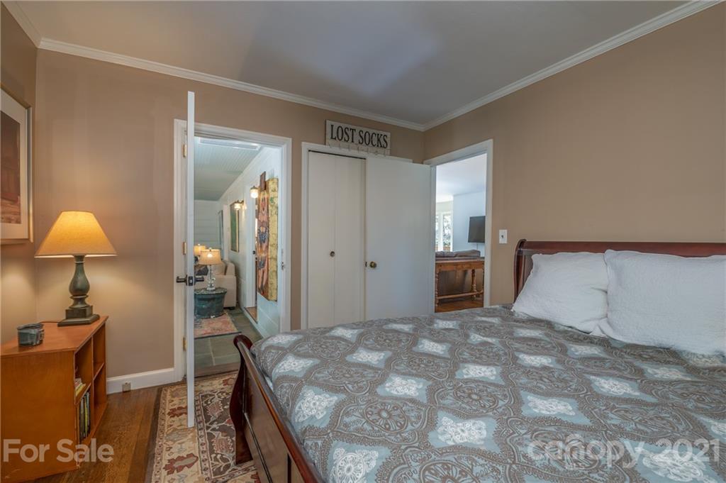 172 Wilderness Road Tryon, NC 28782 - Photo 34 of 46 a bedroom with a bed and a lamp on a dresser
