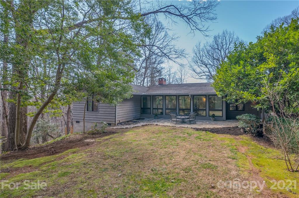 172 Wilderness Road Tryon, NC 28782 - Photo 36 of 46 a view of a house with a yard and large tree