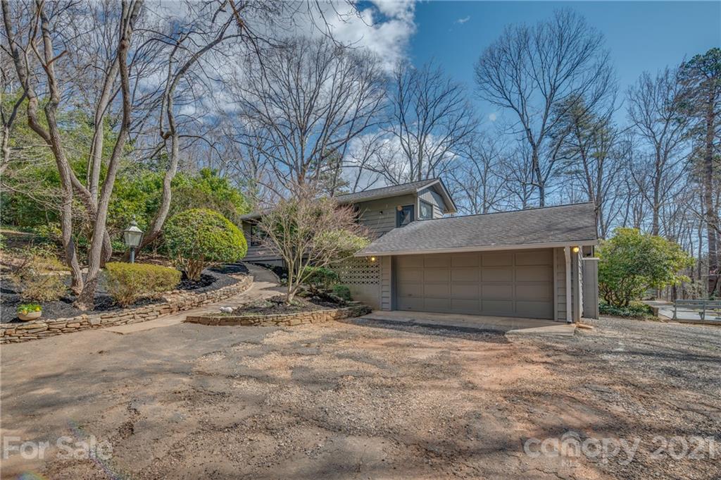 172 Wilderness Road Tryon, NC 28782 - Photo 43 of 46 a front view of a house with a yard and garage