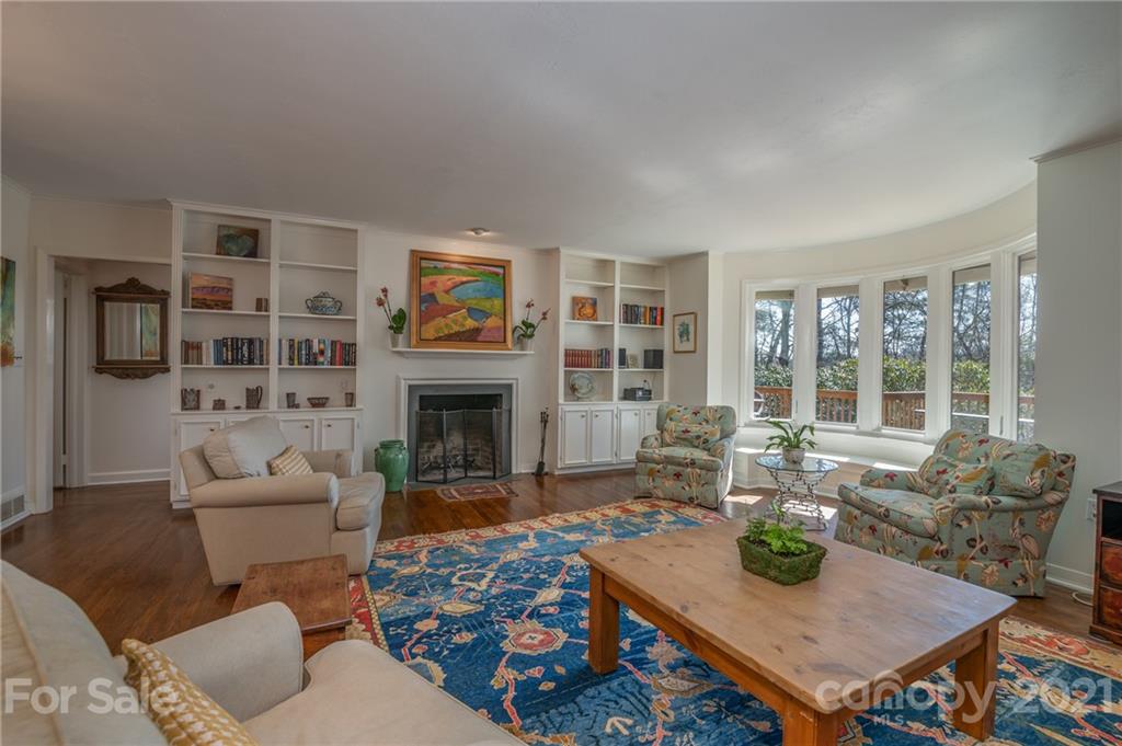 172 Wilderness Road Tryon, NC 28782 - Photo 10 of 46 a living room with furniture a fireplace and a large window