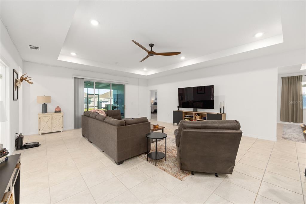 7431 Southwest 65th Place Road Ocala, FL 34474 - Photo 11 of 49 a living room with furniture and a flat screen tv